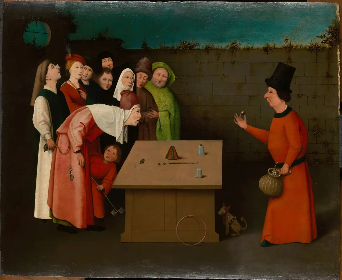 A painting of a conjurer in a tall black hat and red robe at a table, with several onlookers leaning in to watch